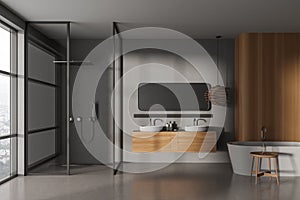 Gray and wooden bathroom with tub, shower and sinks