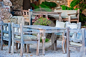 Gray wooden furniture in an outdoor restaurant