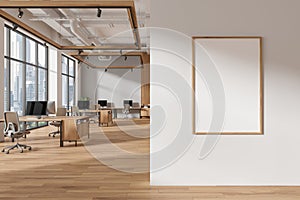 Gray and wooden open space office interior with poster