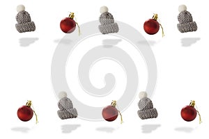 Gray woolen cap whit pompon and  red Christmas baubles pattern on white