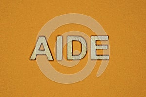 Gray word aide made of wooden letters