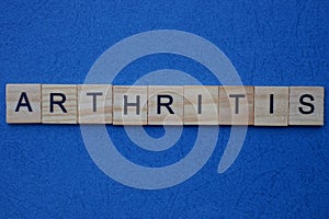 Gray word arthritis from wooden small letters