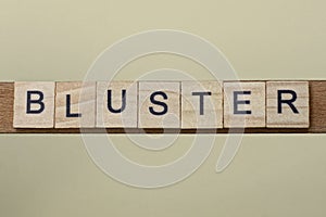 Gray word bluster made of wooden square letters