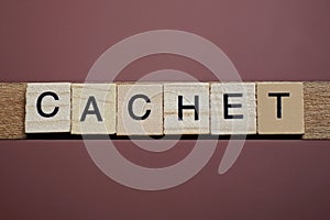 gray word cachet made of wooden square letters photo