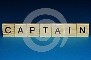 Gray word captain in small wooden letters