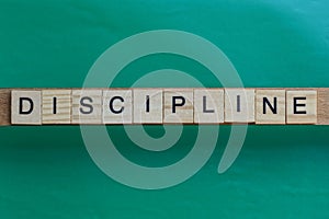 Gray word discipline made of wooden square letters