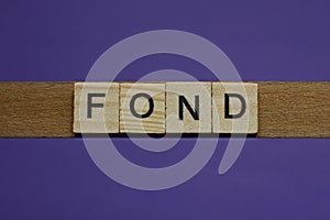 gray word fond in small square wooden letters