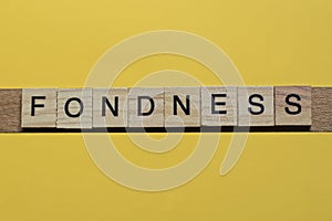 The gray word fondness of gray small wooden letters photo
