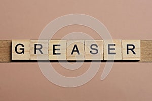 gray word greaser made of wooden square letters