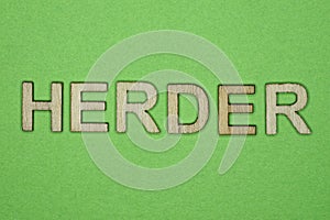 Gray word herder from small wooden letters