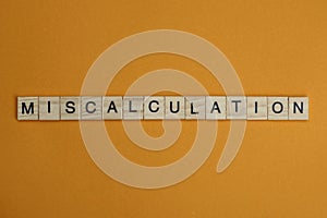 Gray word miscalculation made of wooden square letters photo