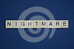 Gray word nightmare from small wooden letters