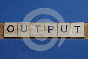 Gray word output in small square wooden letters