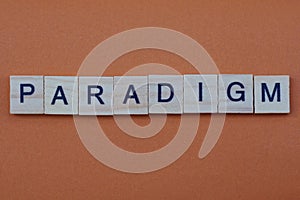 Gray word paradigm from small wooden letters