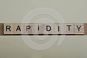 gray word rapidity made of wooden square letters