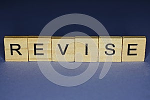 Gray word revise in small wooden letters