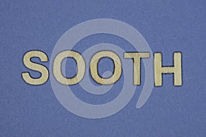 Gray word sooth in small wooden letters photo