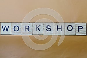 Gray word workshop made of wooden square letters