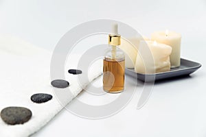 Gray zen pebble hot stones with towel on massage table in beauty salon. Hot stone massage setting.