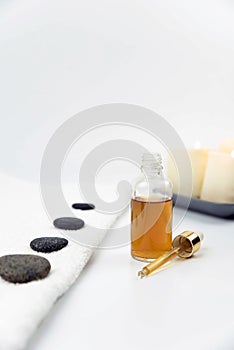 Gray zen pebble hot stones with towel on massage table in beauty salon. Hot stone massage setting.