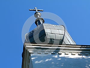 Gray zink cladded church clock tower. onion shaped segmented cupola