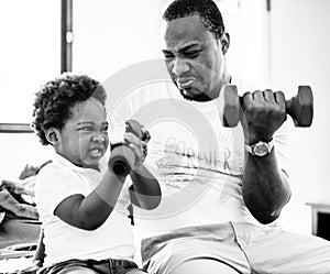 Grayscale of black family exercising