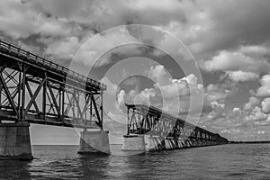 Grayscale of a bridge in Maraton, Keys island, Florida under a cloudy sky