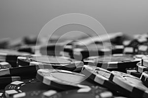 Grayscale closeup of a pile of poker chips on the table