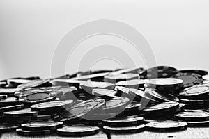 Grayscale closeup of a pile of poker chips on the table