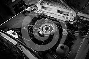 Grayscale high angle shot of an old car engine interior