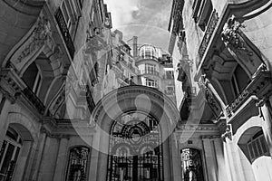 Grayscale low angle shot of antique Paris stone architecture