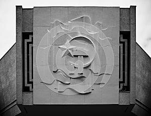 Grayscale of a monument with communism logo on it