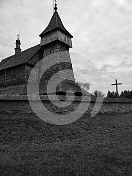 Grayscale shot of an aged wooden church in Old Village, Poland