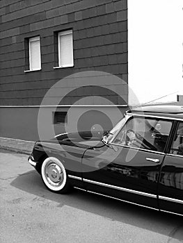 Grayscale shot of a black vintage car