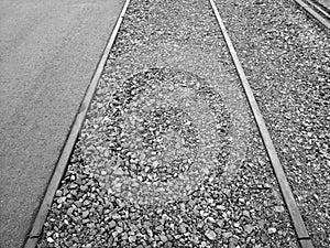 Grayscale shot of gravel between old rails at the harbor in Offenbach, Germany