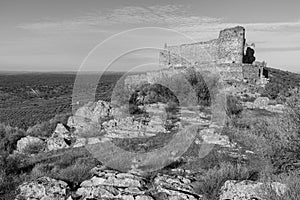 Grayscale shot of Marmionda Castle ruins in Portezuelo, Spain