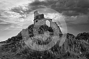 Grayscale shot of the Mow Cop Castle under a cloudy sky in England, the UK