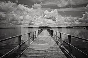 Grayscale shot of a pier at a Mississippi reservoir