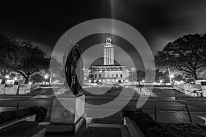 Grayscale shot of the UT tower and the statue of George Washington at night