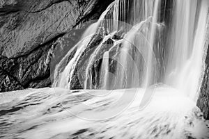 Grayscale shot of a waterfall