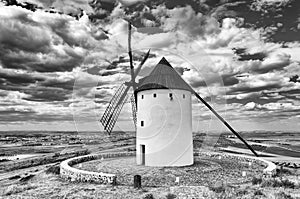 Grayscale shot of windmill in Castilla La Manha village Spain photo