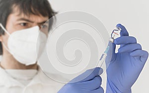 Graz,Austria-26.01.2021: Doctor holding a vaccine bottle and syringe, beginning of mass vaccination with the Moderna COVID-19