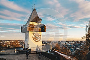 Graz city landmark Schlossberg park tower at sunset and city pan