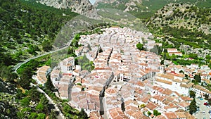 Grazalema, Andalusia. Aerial view of whitewashed houses sporting rust-tiled roofs and wrought-iron window bars