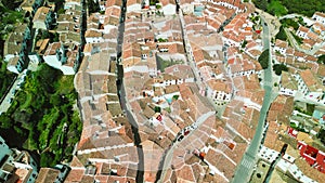 Grazalema, Andalusia. Aerial view of whitewashed houses sporting rust-tiled roofs and wrought-iron window bars