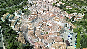 Grazalema, Andalusia. Aerial view of whitewashed houses sporting rust-tiled roofs and wrought-iron window bars