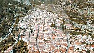 Grazalema, Andalusia. Aerial view of whitewashed houses sporting rust-tiled roofs and wrought-iron window bars