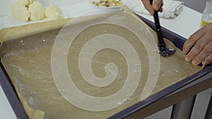 Grease a baking tray lined with baking paper with coconut oil using a brush.