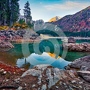 Great autumn view of Fusine lake. Colorful morning scene of Julian Alps with Mangart peak on background, Province of Udine, Italy,