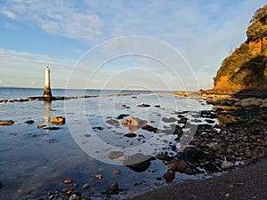 Great Basses Reef Lighthouse against the blue sunny sky